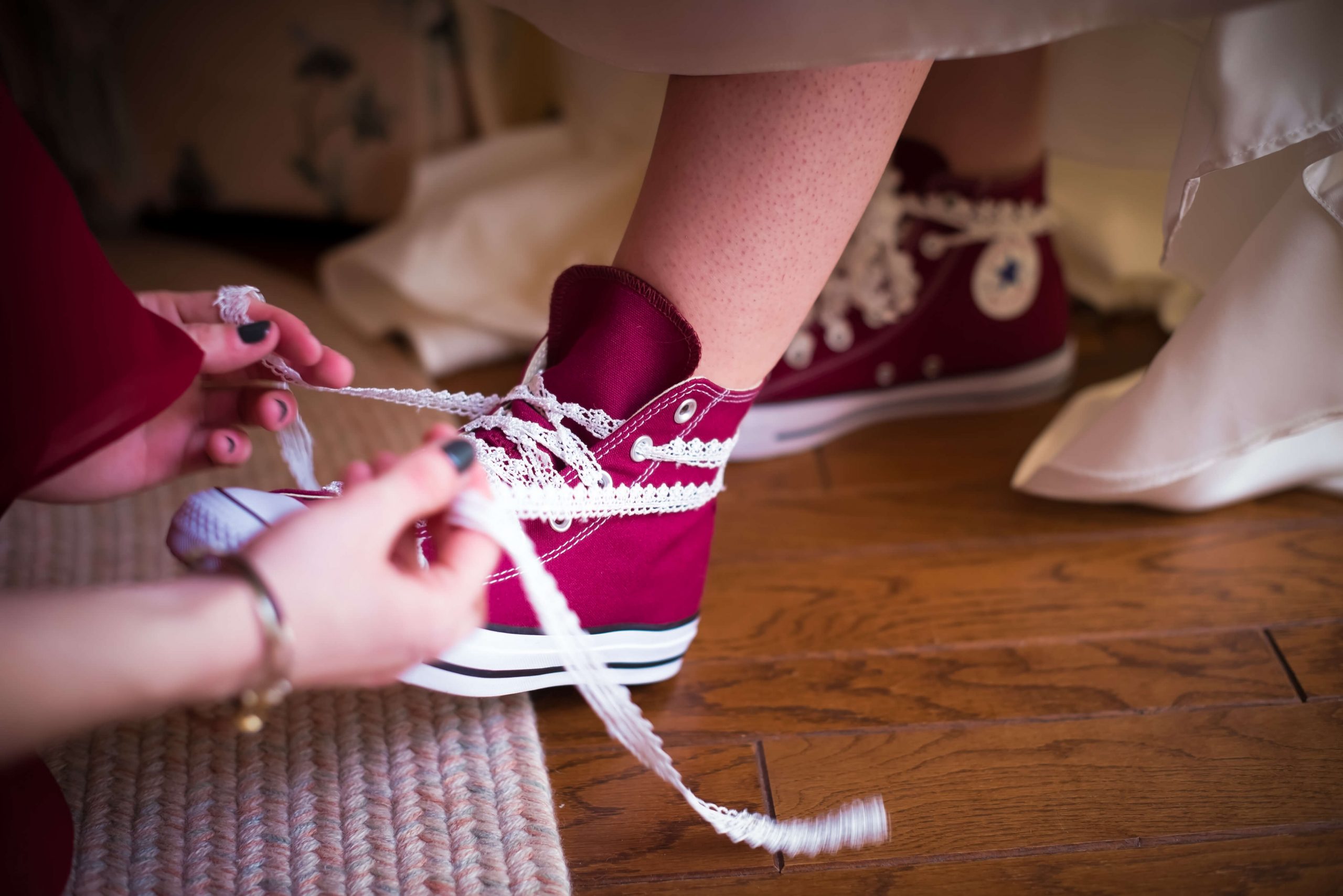 wedding photography pre ceremony bride lacing converse sneakers
