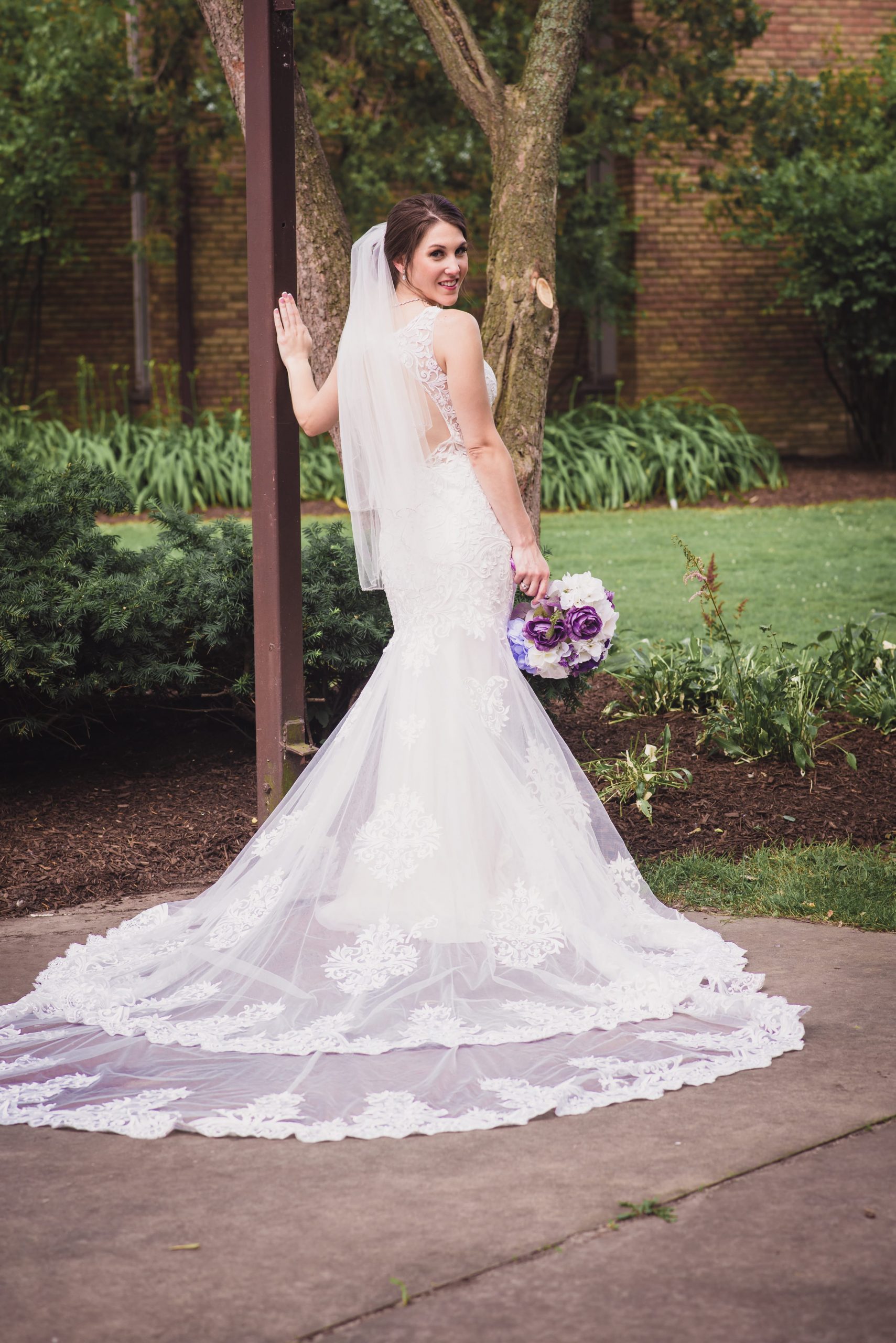 The Real Detroit Wedding of Sara and Jeffrey - Mike Staff Productions bride looking back in portrait, showing dress details