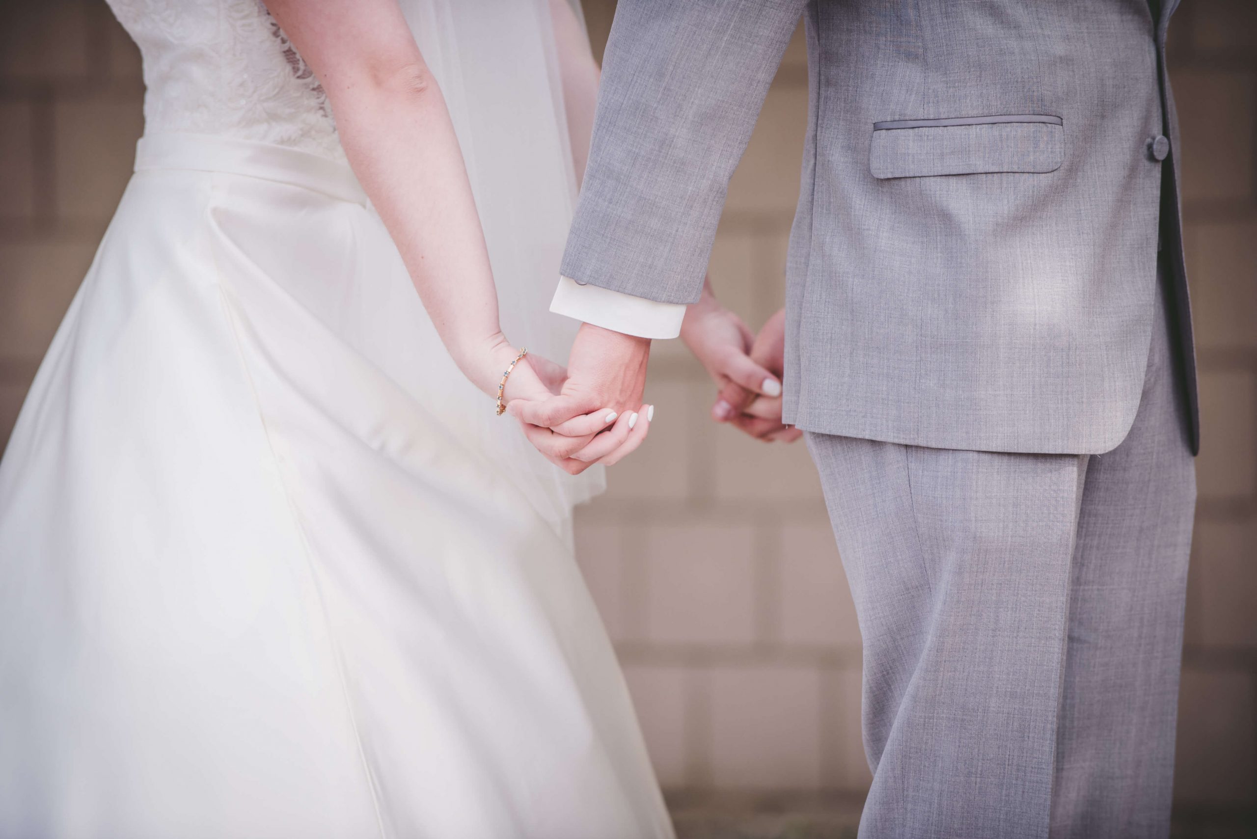 wedding photography bride and groom holding hands