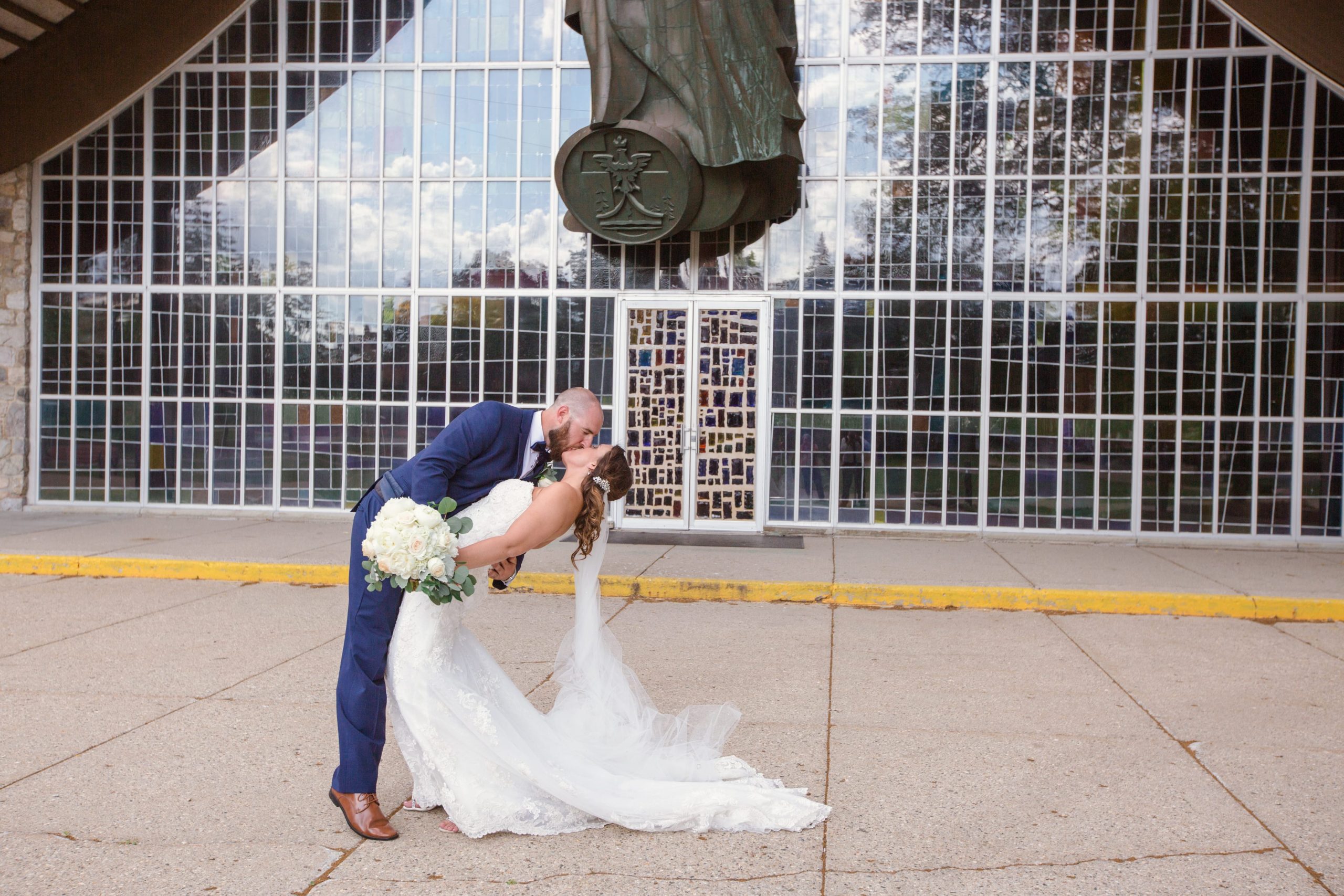 The Real Detroit Wedding of Kayla & Matthew - Mike Staff Productions bride and groom kissing outside church