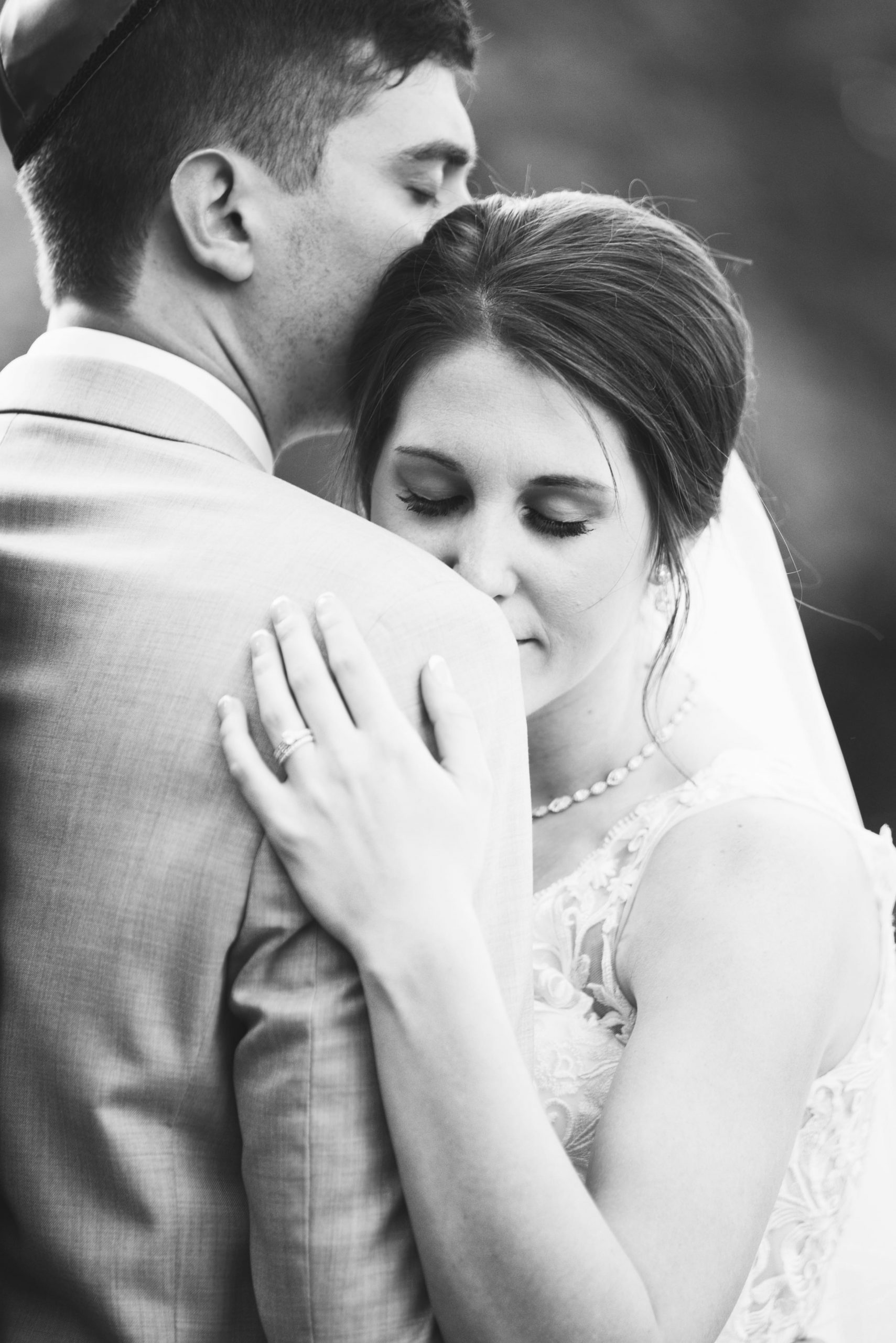 The Real Detroit Wedding of Sara and Jeffrey - Mike Staff Productions black and white photo of bride leaning on groom's shoulder