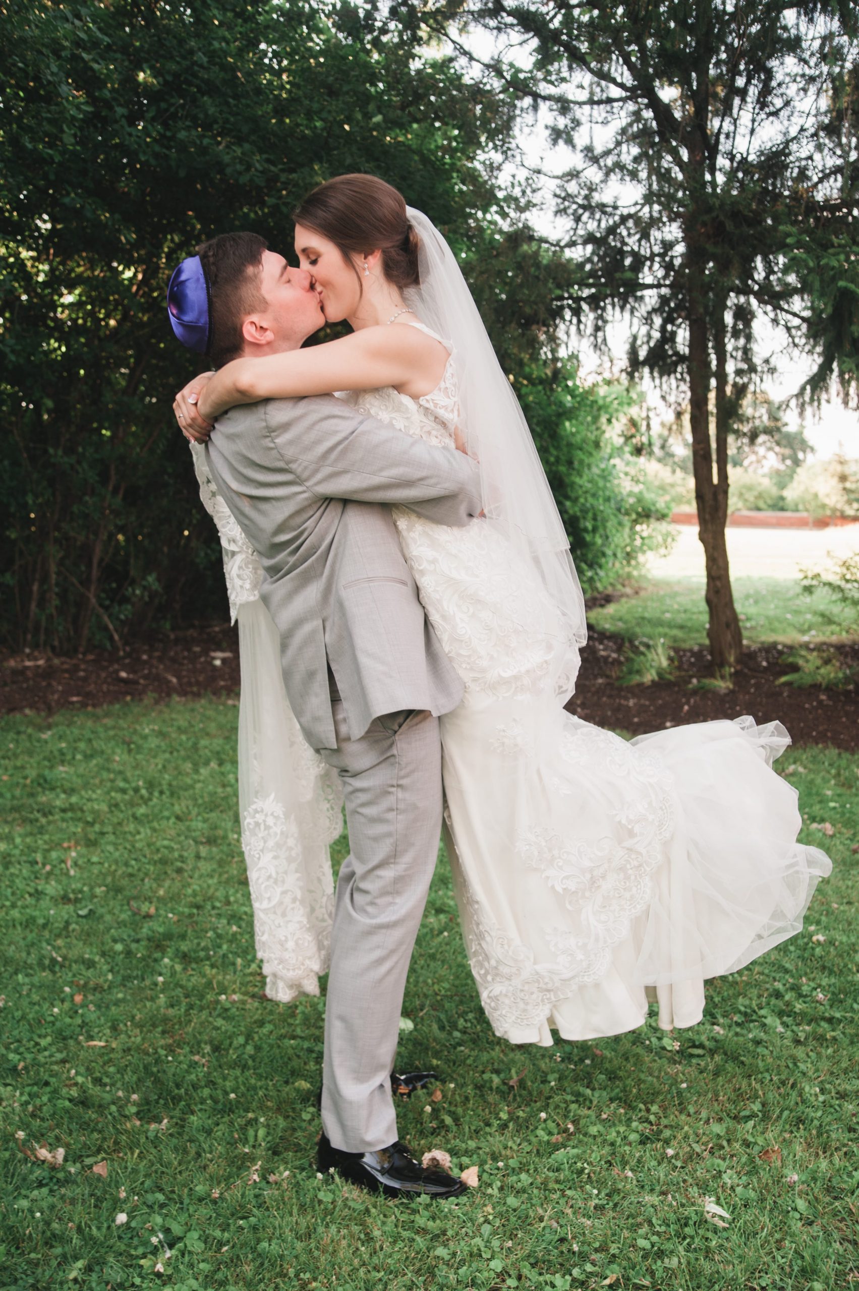 The Real Detroit Wedding of Sara and Jeffrey - Mike Staff Productions groom lifting bride in air to kiss her