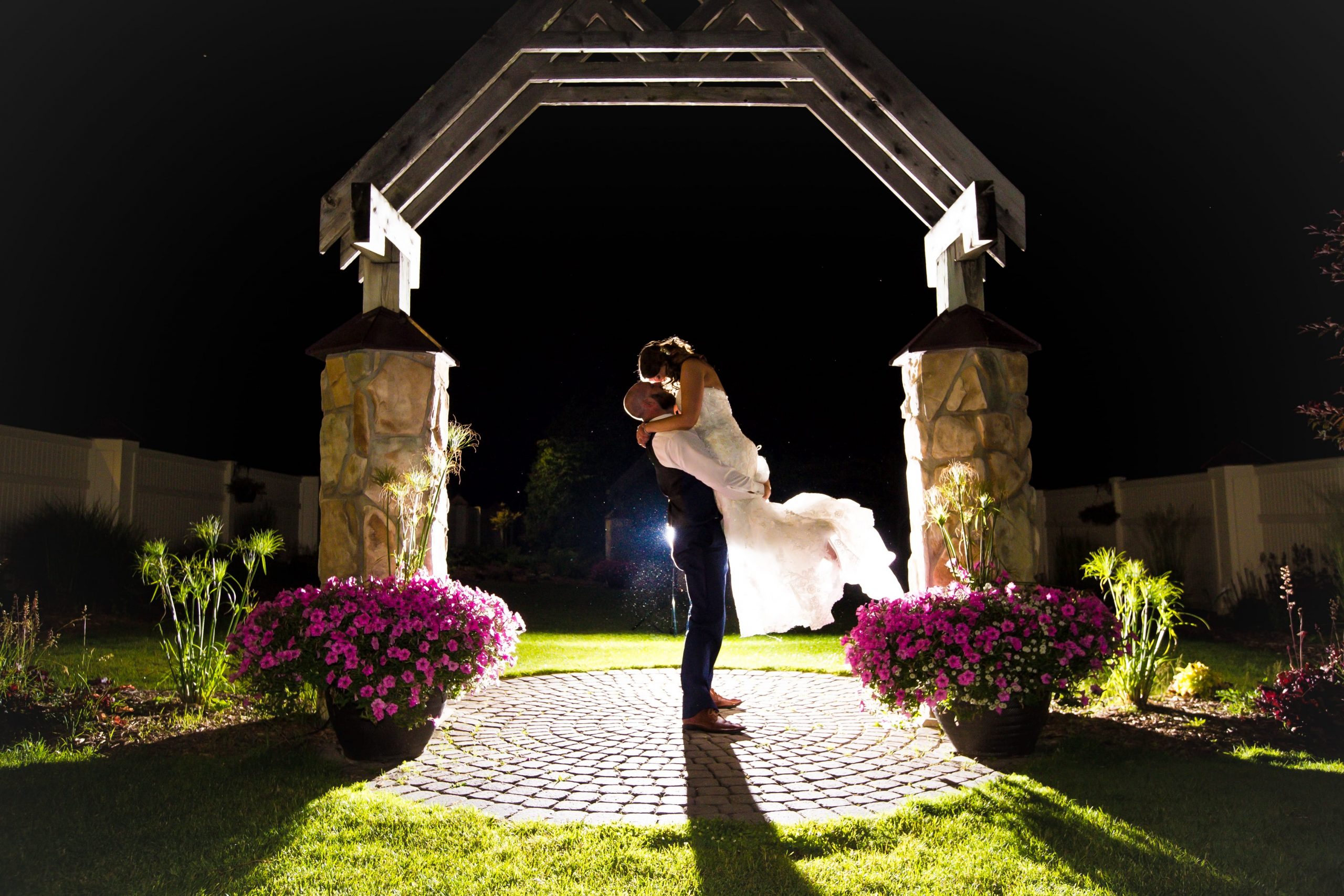 The Real Detroit Wedding of Kayla & Matthew - Mike Staff Productions groom lifting bride for evening romantics