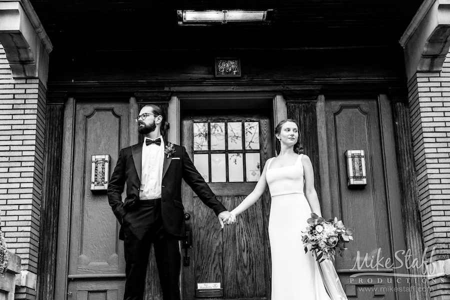 black and white bride and groom holding hands - Mike Staff Productions amanda and michael's detroit whiskey factory wedding