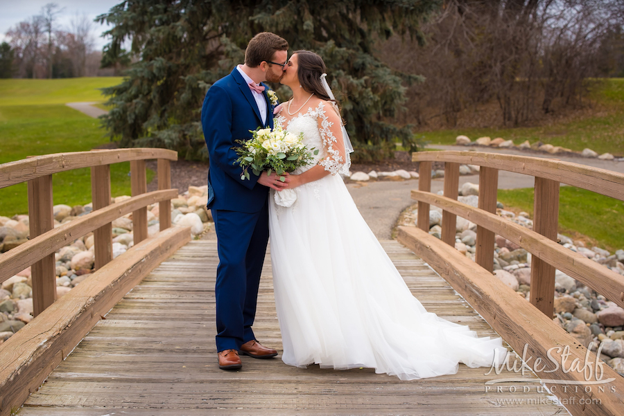 bride and groom kissing on bridge - Mike Staff Productions bride and groom kissing on bridge