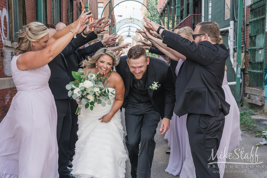 bride and groom running through bridal party - Mike Staff Productions bride and groom running through bridal party