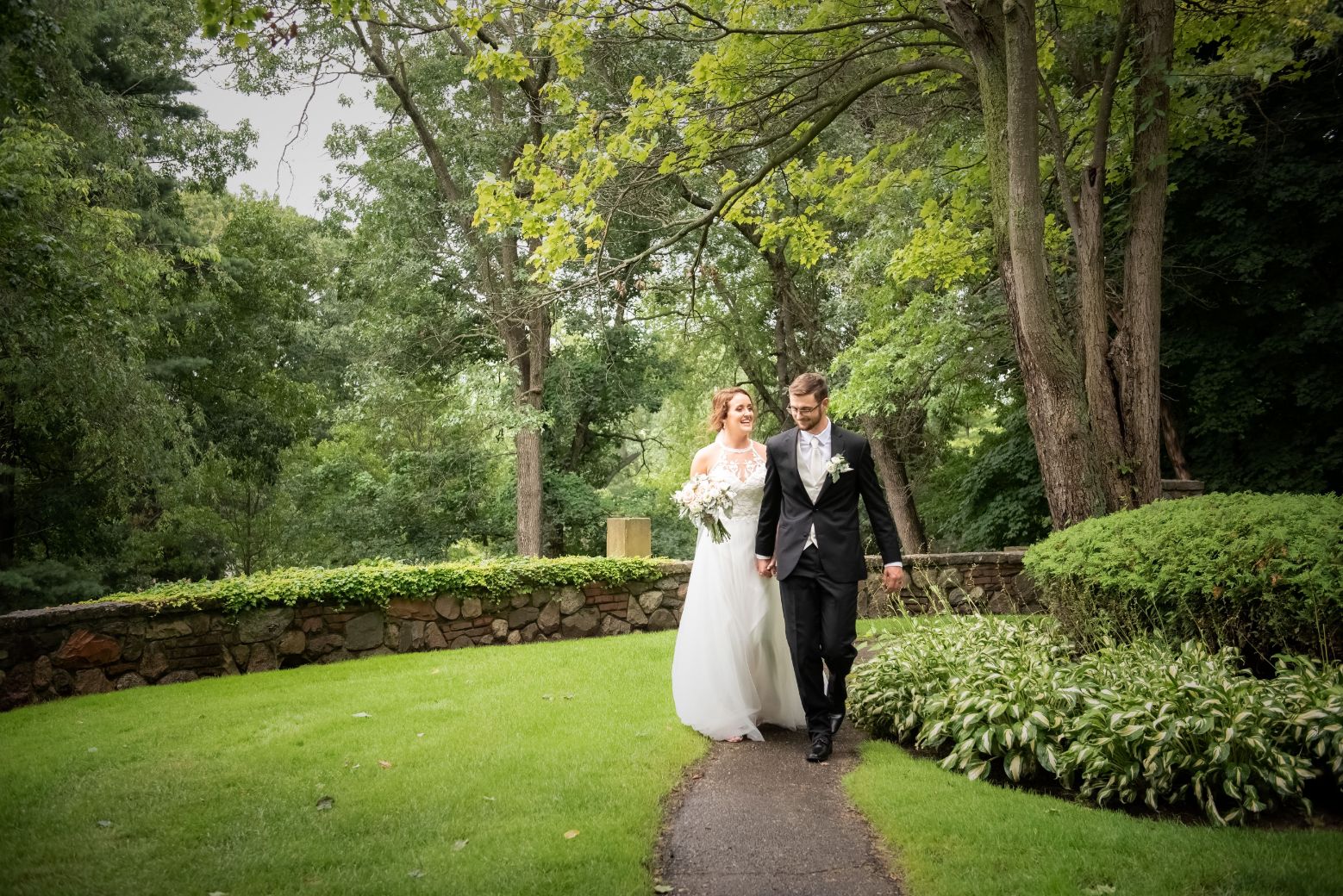 bride and groom walking in gardens - Mike Staff Productions