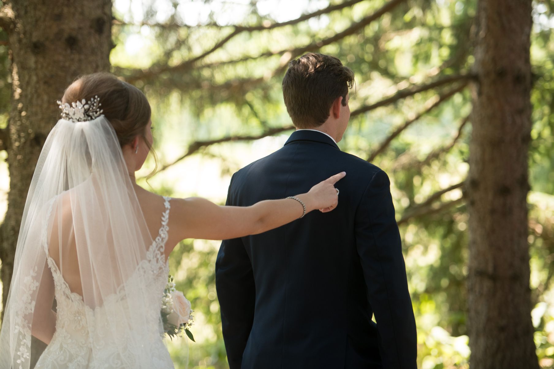 bride tapping grooms shoulder for first look - Mike Staff Productions