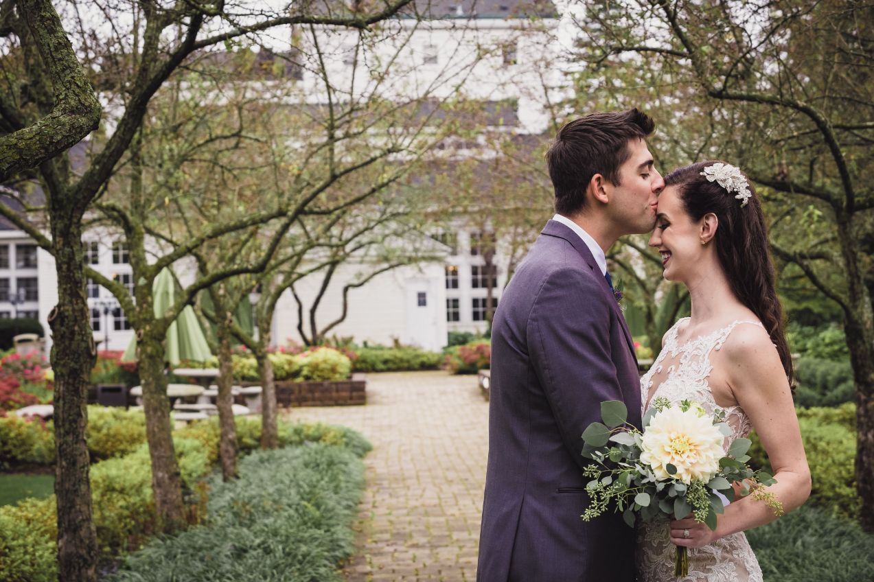 groom kissing bride on forehead - Mike Staff Productions groom kissing bride on forehead