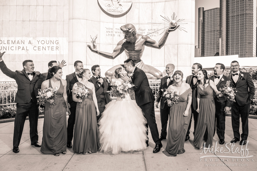 mikestaff-8 - Mike Staff Productions bride and groom kissing in detroit surrounded by bridal party