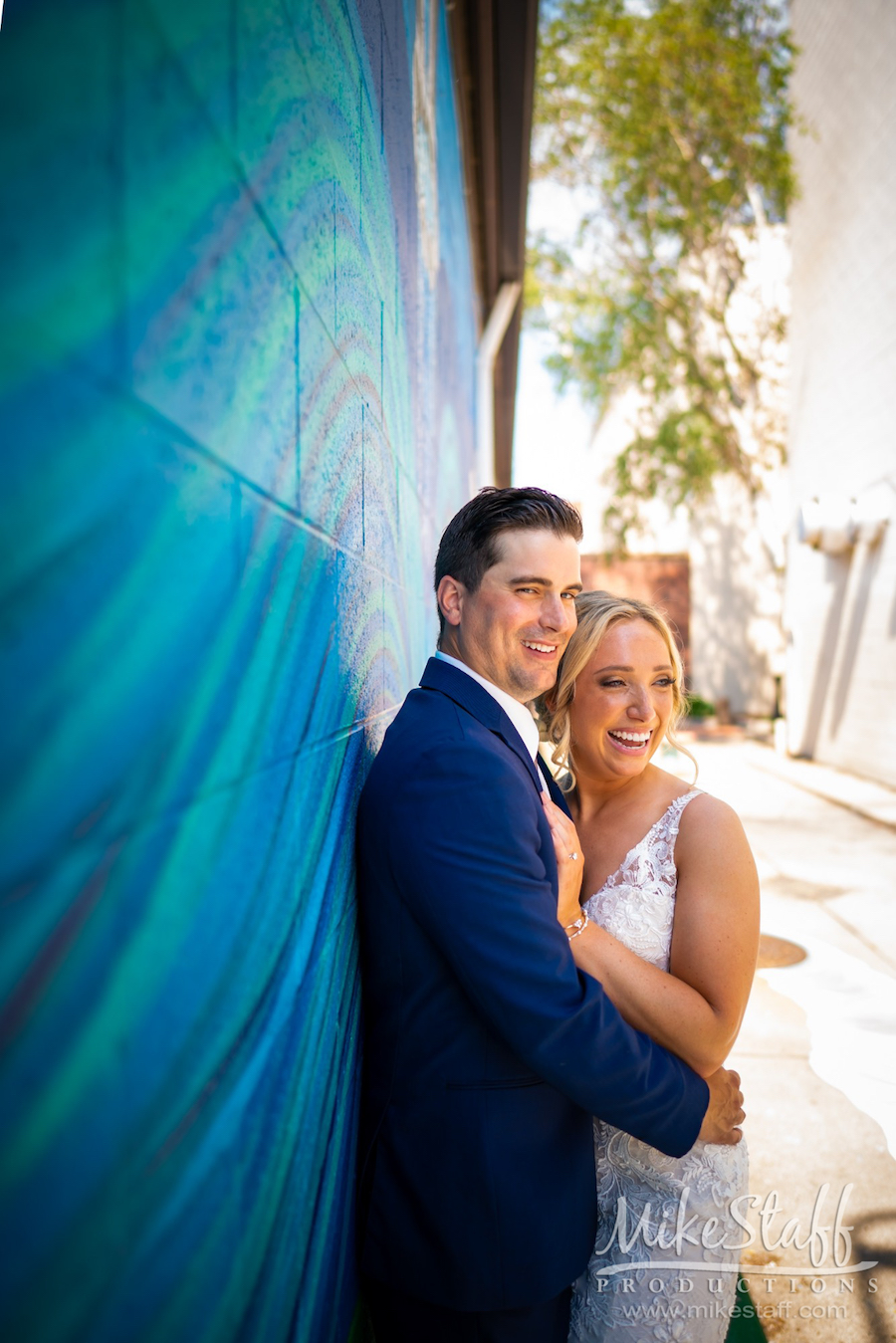 mikestaff-15 - Mike Staff Productions bride and groom by wall mural