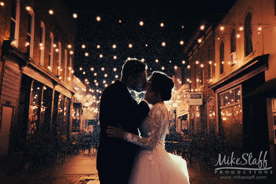outside downtown holly kissing under lights - Mike Staff Productions Miriah and Andrew's Wedding at The Holly Vault