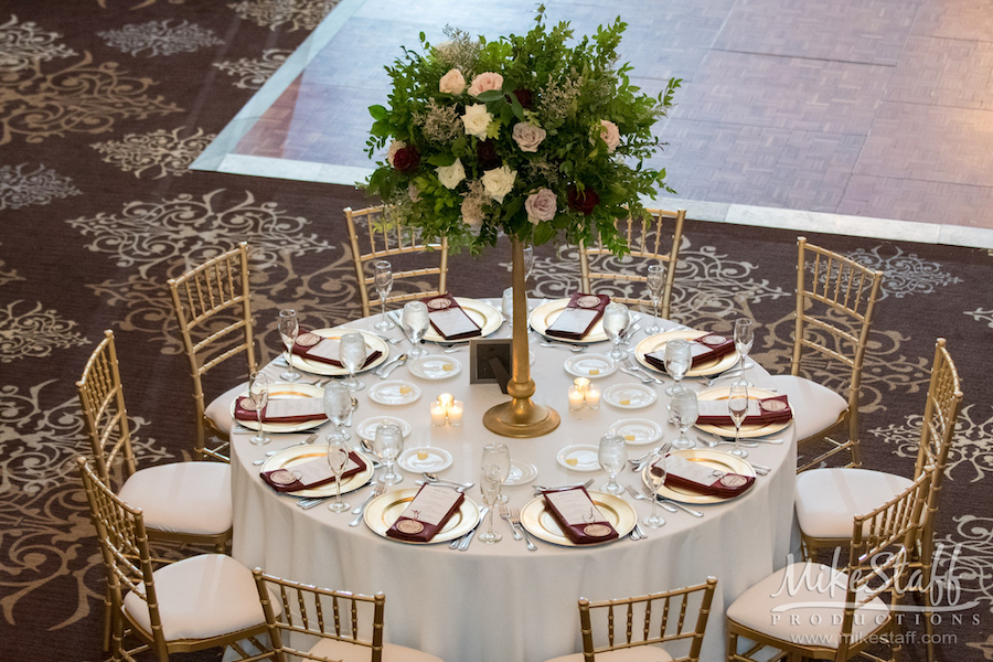 reception centerpiece with tall gold base and large floral arrangement - Mike Staff Productions reception centerpiece with tall gold base and large floral arrangement